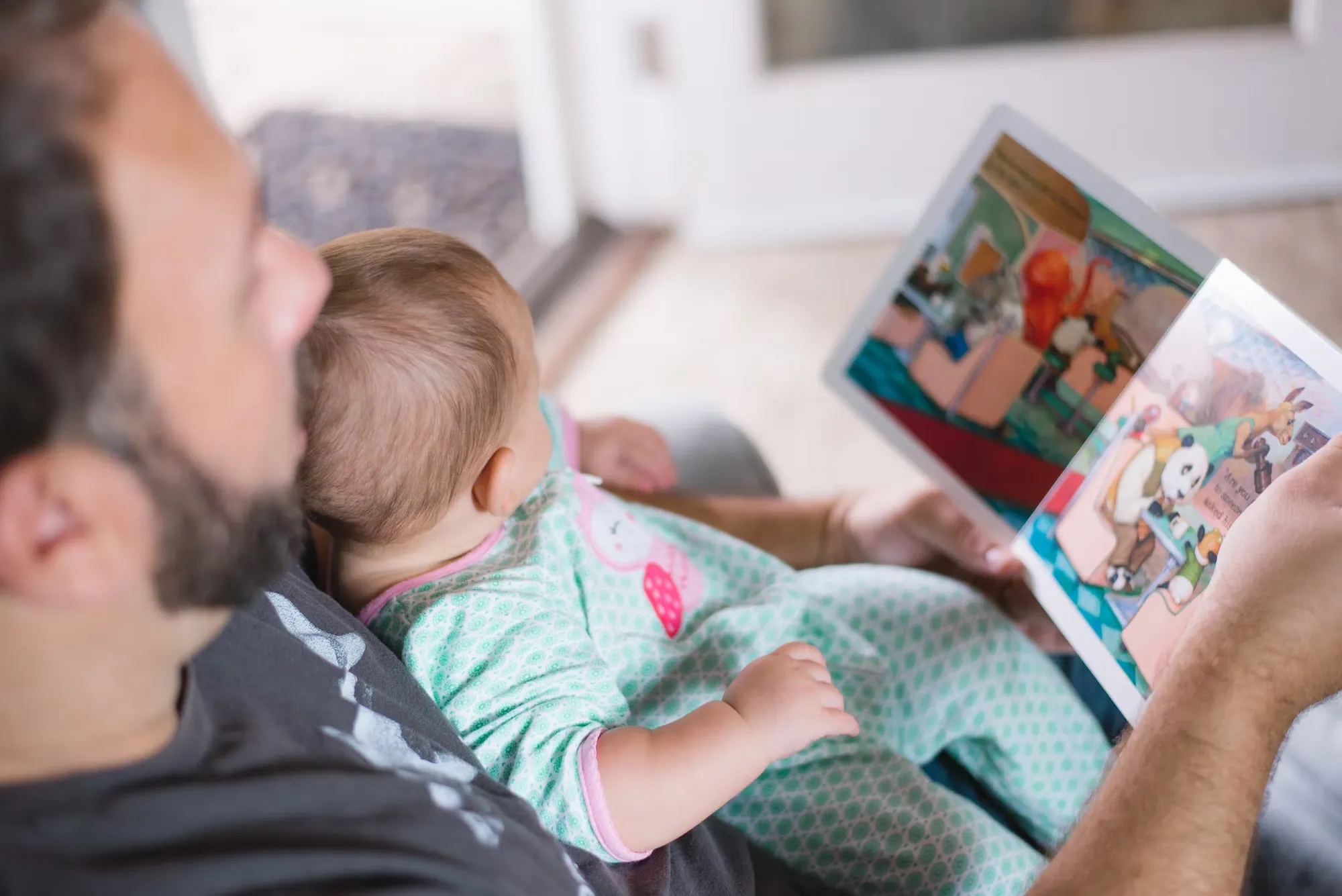 

This image shows a young girl sitting in a comfortable chair, reading a book with a smile on her face. She is surrounded by a variety of books, suggesting that she has a wide selection to choose from. The image conveys the joy