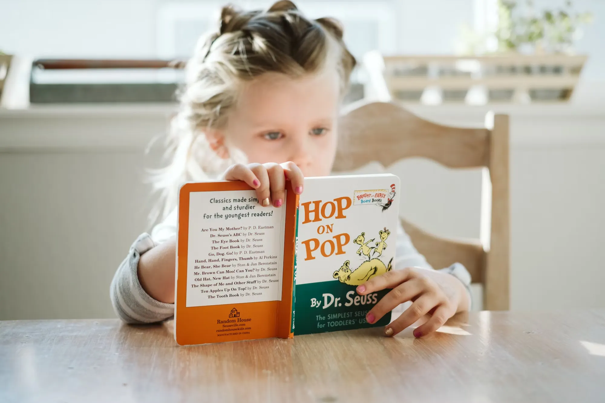 

This image shows a young girl sitting in a comfortable chair, surrounded by books. She is happily reading a book, with a contented smile on her face. The image illustrates the positive benefits of reading for children, such as increased knowledge,